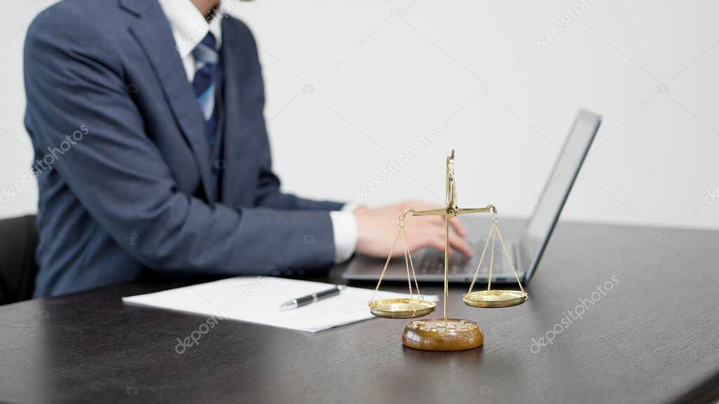Legal expert reviewing documents at a desk